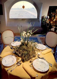 a dining room table with plates and silverware on it