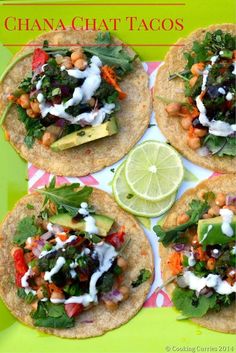 four tortillas topped with vegetables and garnishes on a green plate