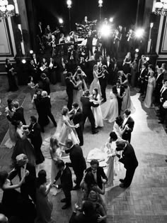 a group of people standing around each other on top of a dance floor