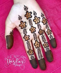 the hand is decorated with flowers and leaves