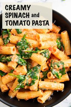 creamy spinach and tomato pasta in a black bowl on a marble countertop with text overlay