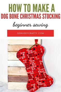 a dog bone christmas stocking hanging on a wooden crate with text overlay that reads learn to sew a dog bone christmas stocking