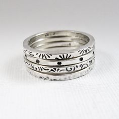 A set of four stacking rings are hand fabricated from sterling silver.  They've been stamped with patterns and have been hammered.  The patterns are oxidized to contrast with the shiny white silver.  The edges are beveled for comfort.  This set includes sunbursts, polka dots, small swirls, and hammered.  Wear them stacked together or one, two, or three at a time.   Because they are made to order, and are handmade, there will be subtle differences from the rings pictured.  Each ring measures about 1.6mm. wide and set together they are just a hair over 7mm. wide. I will also customize the stampings for you, or leave them unpatterned.  There is also the possibility of stamped wording.  Contact me to requst variations.  If you are interested in purchasing rings like these individually, or orde Sterling Silver Rings Boho, Metal Stamped Jewelry, Stacker Rings, Stamped Rings, Metal Clay Jewelry, Dope Jewelry, Jewelry Lookbook, Stamped Jewelry, Jewelry Inspo