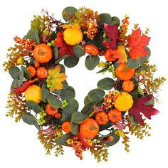 a wreath with oranges, leaves and berries on it is displayed against a white background