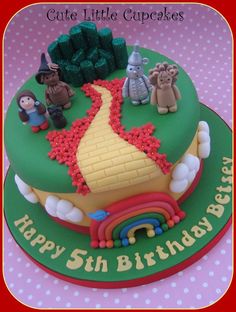 a birthday cake decorated with legos and animals on it's side is shown