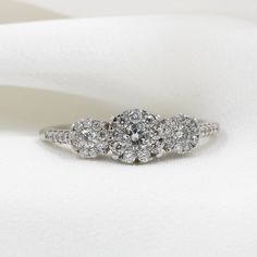 three stone diamond ring on white fabric