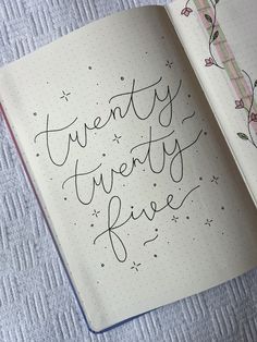 an open notebook with writing on it and the words twenty twenty five written in cursive ink