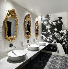 a bathroom with three sinks and two mirrors on the wall next to eachother