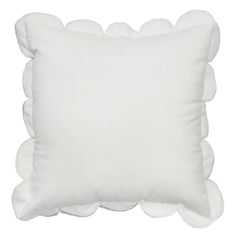 a white pillow with scalloped edges