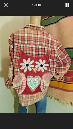 an owl shirt is displayed on a mannequin's head, next to a colorful blanket