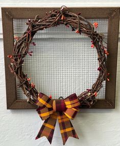 a wreath with two bows hanging on the wall