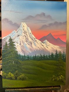 a painting of a mountain with trees in the foreground and a sunset behind it