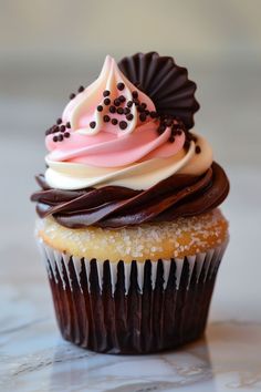 a cupcake with chocolate and pink frosting