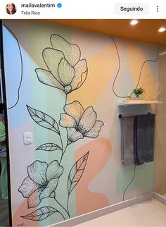 a bathroom wall with flowers painted on it