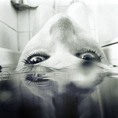 a woman's face with the words just remember above her eyes and in the water