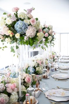 a long table is set with flowers and candles for an elegant dinner or reception party