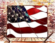 an american flag stained glass window in front of a brick wall