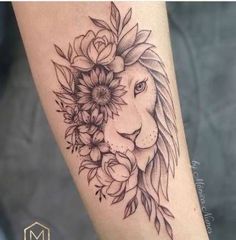 a woman's arm with a lion and flowers on it