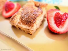 some food is sitting on a plate with strawberries and other foods in the background