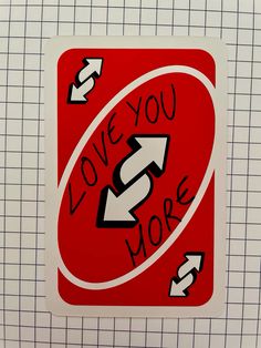 a sticker with the words love you more and an arrow pointing up to it