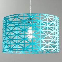 a blue light hanging from a ceiling fixture with an intricate design on the bottom and sides