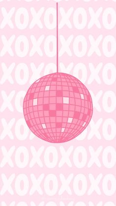 a pink ball hanging from the ceiling in front of an xoxo wallpaper