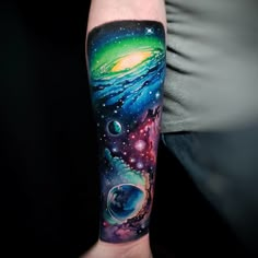 a man with a tattoo on his arm that has an image of planets and stars in the sky