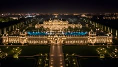 the palace is lit up at night with lights shining on it's facade and surrounding gardens