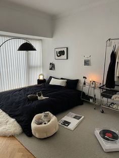 a bedroom with a record player on the floor next to a bed and other items