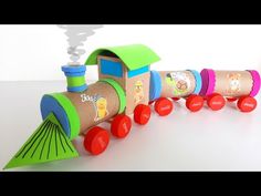 a wooden toy train with different colored wheels