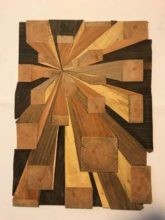 a piece of wood that has been cut into squares and arranged in the shape of a sunburst