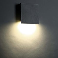 a light that is on the side of a wall with a square light in it