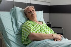 an older woman laying in a hospital bed