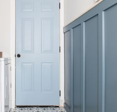 a blue door in a white room