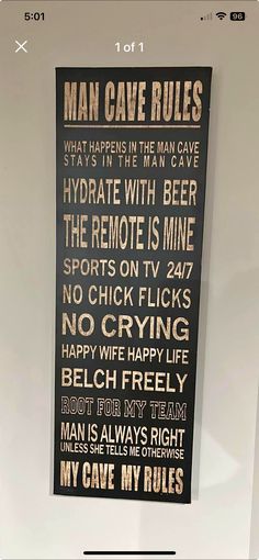 a black and white sign with words on it in front of a door that says man cave rules