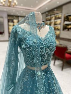 Get ready to rock your wedding day with our Teal Blue Bridal Lehenga BL-102. This stunning lehenga features a gorgeous teal blue color that will make you stand out as you walk down the aisle. With intricate embroidery and elegant design, this lehenga is perfect for a bride who wants to make a statement. (Sorry, tiara not included!) Fabric: Net with Satin Silk Lining! WASH CARE INSTRUCTIONS - Please Dry clean only when it is applicable! Ready to Ship! Teal Blue Lehenga Jewellery, Turquoise Sharara For Wedding, Elegant Turquoise Wedding Sets, Traditional Blue Gown For Wedding, Blue Fitted Floor-length Sharara, Blue Bollywood Gown With Intricate Embroidery, Blue Traditional Drape Lehenga For Reception, Blue Gown With Intricate Embroidery Semi-stitched, Blue Semi-stitched Dress For Wedding