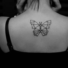 the back of a woman's neck with a geometric butterfly tattoo on her left shoulder