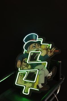 a neon sign that is lit up in the dark with an image of a man on it