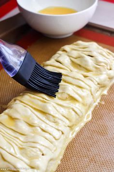 a plastic brush that is on top of some food