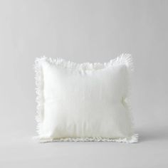 a white pillow with fraying on it