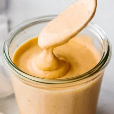 a spoon is in a jar filled with peanut butter