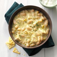 a bowl filled with pasta and cheese next to crackers