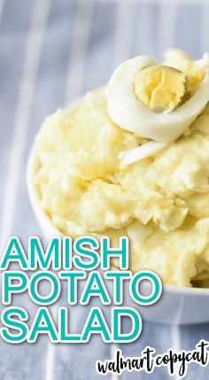 mashed potato salad in a bowl with an egg on top and the words amish potato salad above it