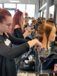 a woman working on a mannequin in a hair salon