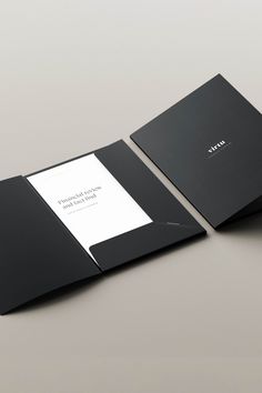 an open black book sitting on top of a table