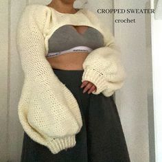 a woman is wearing a cropped sweater and black wide legged pants with her hands on her hips