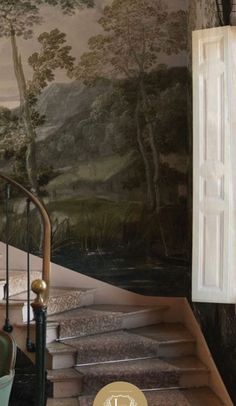 a staircase leading up to a painting on the wall