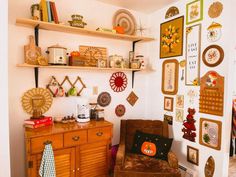 a living room filled with furniture and lots of pictures hanging on the wall above it