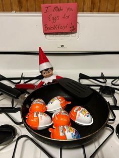 an elf is cooking eggs in a frying pan on top of the gas stove