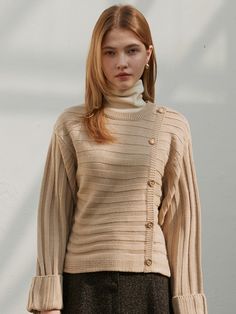 Editor's NotesThis is a knit made of soft acrylic fabric. With its soft texture and warm knitwear, you can wear it as an innerwear in winter.- Gold button- Rolled-up sleeves- Diagonal buttons are unique- Soft and warmMeasurements(in.) One Size (XS-M)- Shoulder: 19.1 in. - Chest: 18.5 in. - Sleeve length: 20.7 in. - Armhole: 11.22 in.- Total length: 20.1 in. * Modelinfo: Height 5' 57, Bust 29 in., Waist 23.5 in., Hips 34 in. * Sizing inconsistency may occur within 0.4 inchesto 1.18 inches. Composition &Care - 100% SOFT ACRYLIC- Dry Clean Only Designer - by JOORTI Cozy Beige Acrylic Top, Cream Sweater With Button Closure For Winter, Cream Knit Tops With Buttons, Beige Buttoned Sweater For Fall, Fall Beige Buttoned Sweater, Fall Beige Button Sweater, Beige Acrylic Cardigan, Beige Long Sleeve Sweater With Button Closure, Beige Acrylic Cable Knit Sweater